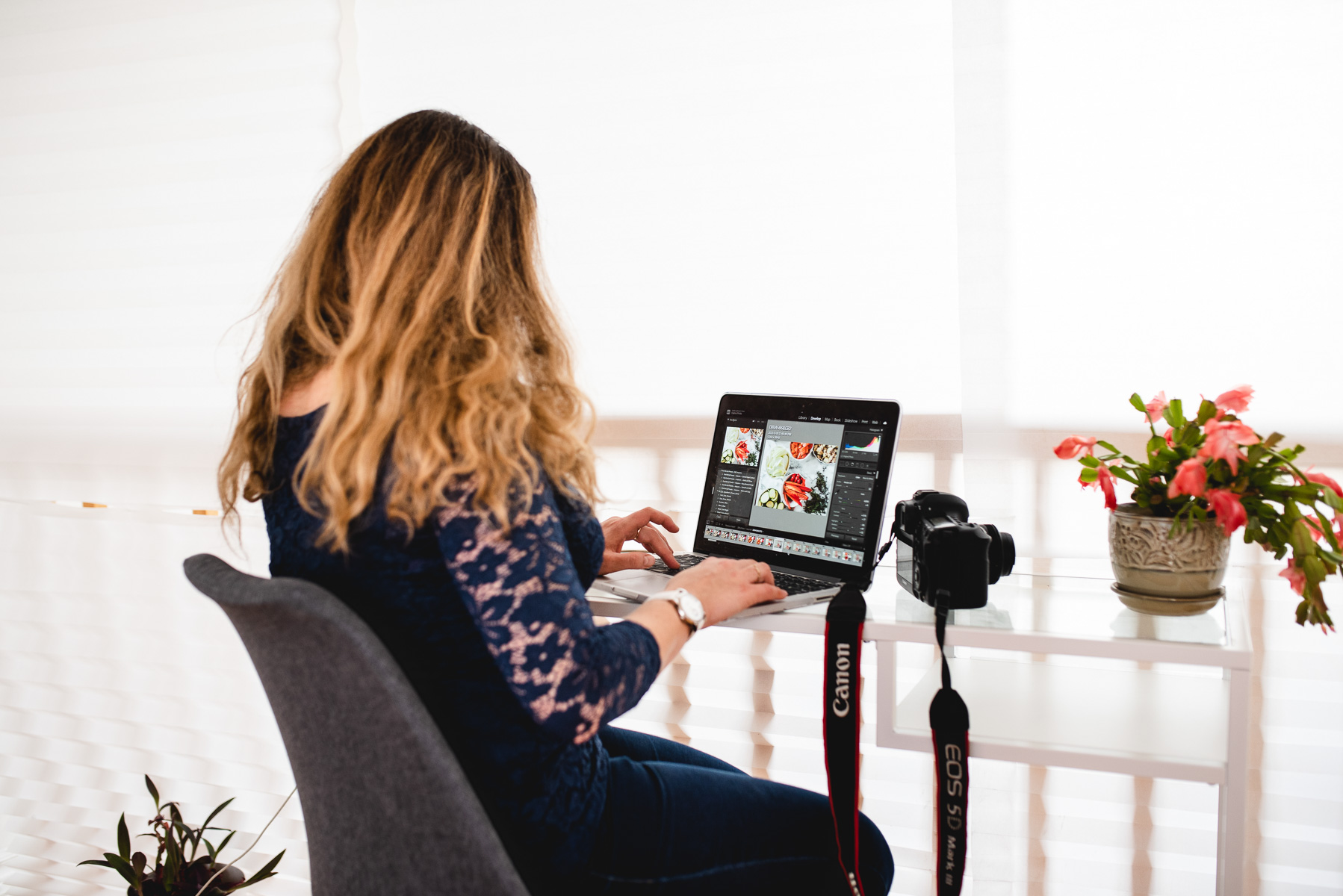 Woman sitting at dest, typing on computer