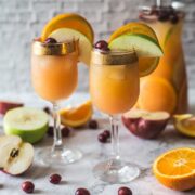 close up on two glasses with orange cranberry sangria mocktail